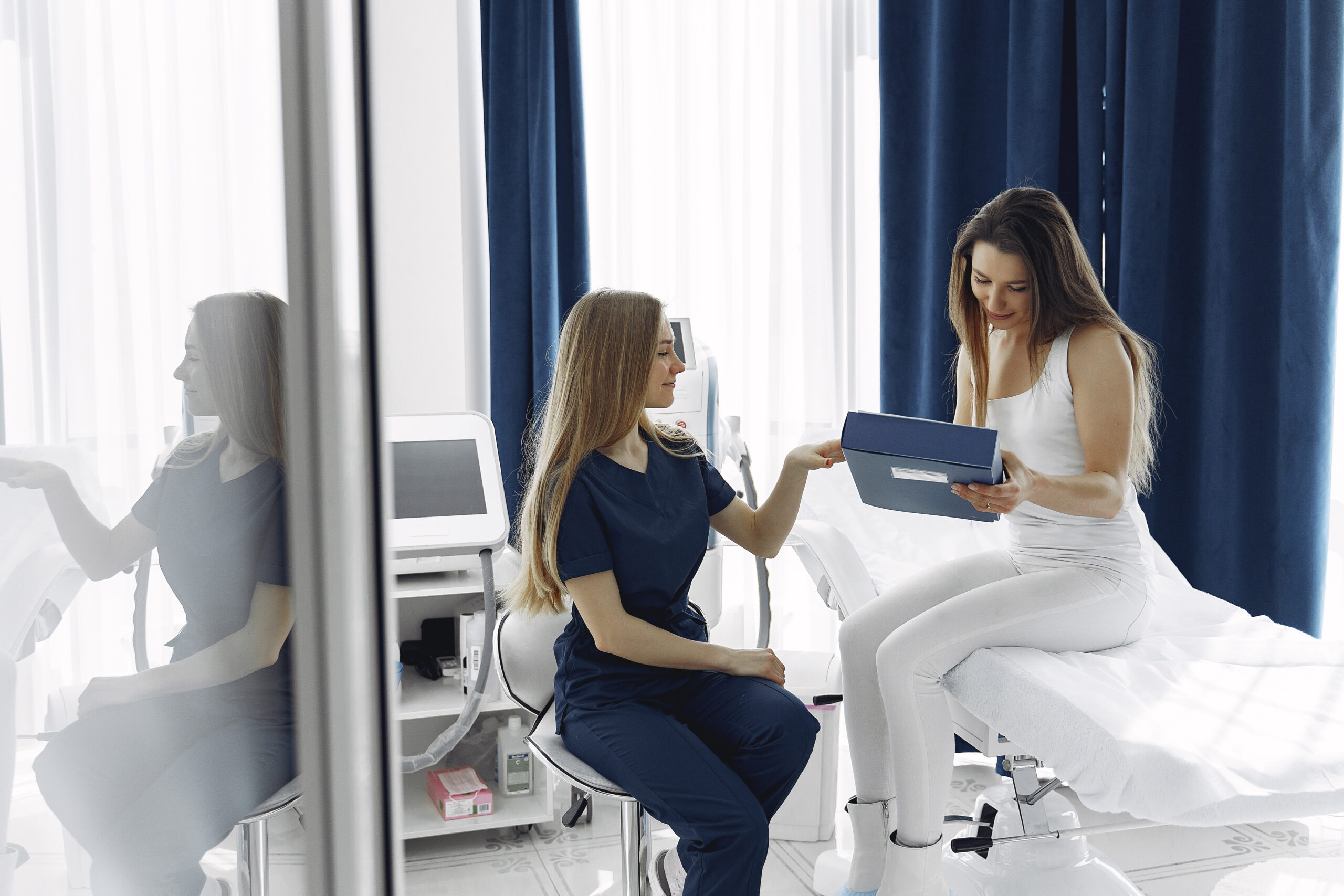 Photo of a woman being advised by her doctor after her emsculpt neo appointment